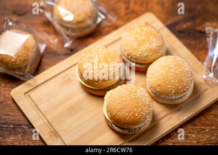 Hamburger surgelati su sfondo di legno. Semilavorato per cottura veloce. Fast food. Foto Stock