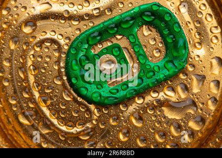 Lattina di birra vista dall'alto, primo piano. L'occhio verde per l'apertura del vaso è chiaramente visibile. Banca in gocce d'acqua Foto Stock