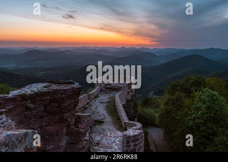Moody sorge sulle rovine del castello di Wegelnburg, sulle rocce di arenaria e sulle foreste dei Monti Palatinati, Renania-Palatinato, Germania Foto Stock