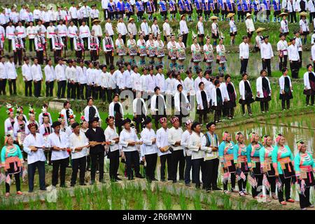 Diecimila persone cantano la grande canzone del gruppo etnico Dong nella campagna del villaggio di Dong a Qiandongnan, provincia di Guizhou, Cina, giugno Foto Stock