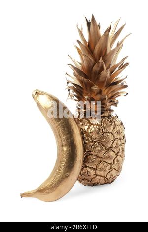 Ananas dorato lucido e banana su sfondo bianco Foto Stock