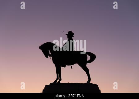 Silhouette della statua del re Edoardo VII e del cavallo, di William Goscombe John, sul Pier Head, molo di Liverpool. Cielo viola dietro. Foto Stock