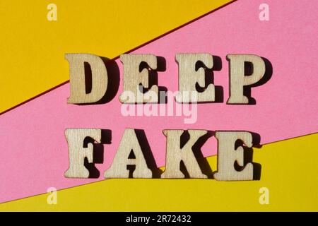 Deep Fake, parole in lettere alfabetiche di legno isolate su sfondo rosa e giallo Foto Stock