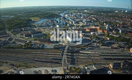 Una vista aerea di un vibrante paesaggio urbano situato in un sereno corpo d'acqua a Odense, Danimarca. Foto Stock