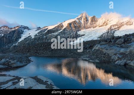 Großglockner picelt lato nord in un piccolo lago di ghiacciaio all'alba, angolo di cascata in condizioni di sole Foto Stock