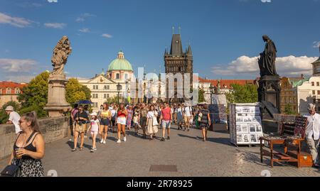 PRAGA, REPUBBLICA CECA - turisti che attraversano il Ponte Carlo. Torre del Ponte della Città Vecchia sul retro. Foto Stock