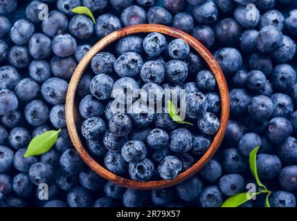 Ai mirtilli freschi con gocce di acqua nel recipiente di legno. Vista dall'alto. Concetto di sano e dieta mangiare Foto Stock