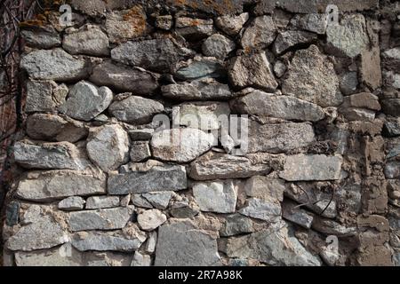 Sfondo medievale di pietre naturali legate con Malta cementizia Foto Stock