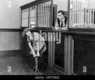 Hollywood, California: 1921. Buster Keaton come un teller di banca e Virginia Fox nel breve silenzioso, 'The Haunted House'. Foto Stock