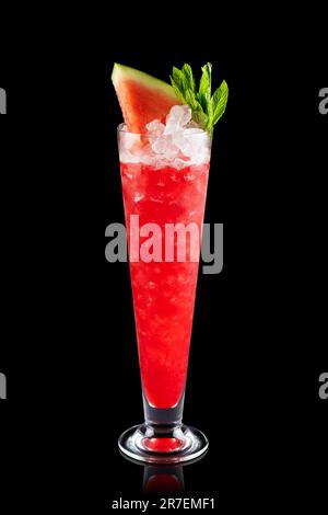 Cocktail di cocomero surgelato alla frutta con vino frizzante e ghiaccio tritato isolato su sfondo nero. Cocktail alcolico fresco. Foto Stock