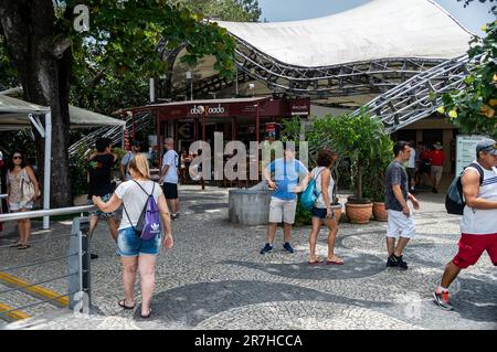 I turisti che camminano nelle vicinanze dell'area ristoro all'aperto sulla cima della collina di Urca, nell'area ricreativa del quartiere di Urca, nei pressi di alcuni negozi durante una giornata di sole estivo. Foto Stock