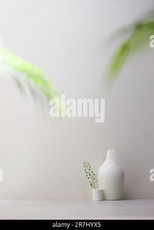 Vasi ed oggetti sul tavolo in una stanza calda con luce solare entrante Foto Stock