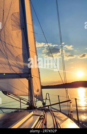 Lo yacht naviga sullo sfondo del sole che tramonta. Foto di alta qualità Foto Stock