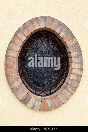 Finestra rotonda con vetrate colorate sulla facciata dell'edificio. Foto Stock