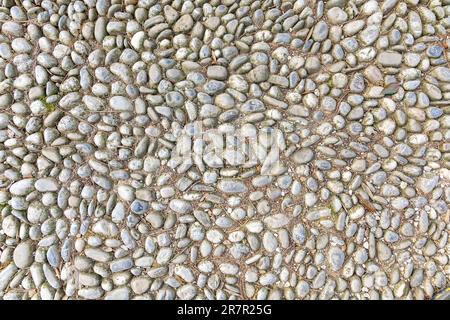 Strada ghiaiosa, sfondo con struttura ciottoli. Sfondo superficie pavimento Foto Stock