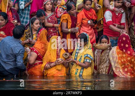 I devoti fanno offerte e pregano nelle Gange durante Chhath Puja a Varanasi, India Foto Stock