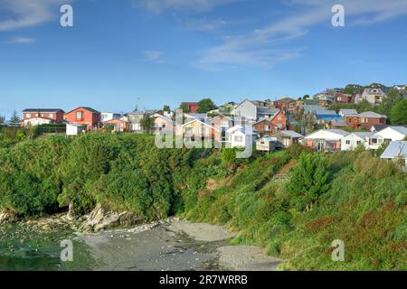 Sviluppo privato sulle pendici vicino alla costa sull'isola di Chiloe, nel Cile meridionale. Foto Stock