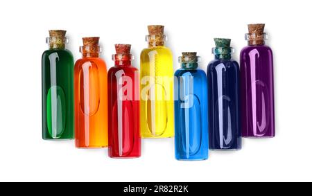 Bottiglie in vetro con diversi coloranti alimentari su sfondo bianco, vista dall'alto Foto Stock