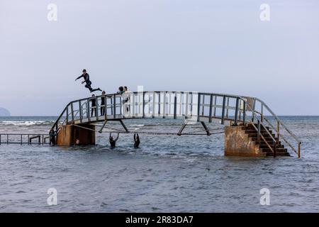 Dunbar, Regno Unito. 18 giugno, 2023 nella foto: I bambini salta dal famoso “Ponte a Nowhere” a Belhaven Bay a Dunbar, East Lothian. Credit: Notizie dal vivo su Rich Dyson/Alamy Foto Stock