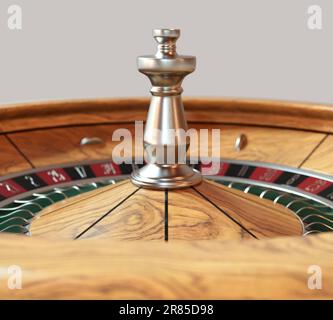 Un primo piano di una moderna ruota della roulette realizzata in legno con pennarelli rossi e neri e dettagli metallici su uno sfondo isolato - rendering 3D Foto Stock