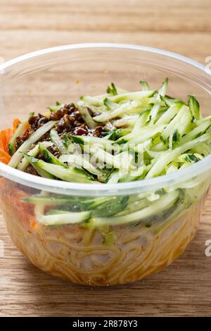 Angolo di vista tradizionale pechinese noodle con pasta di soia in una ciotola da asporto composizione verticale Foto Stock