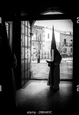 Nazareni con tunica e cappuccio nelle processioni per le strade di Baeza durante la celebrazione della sua tradizionale settimana Santa. Foto Stock