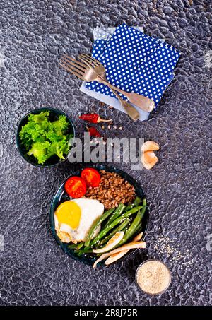 Porridge di grano saraceno con uova bollite, verdure e broccoli Foto Stock