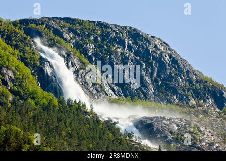 Una cascata potente e maestosa che scende lungo un'aspra montagna, creando una scenografica scena naturale Foto Stock