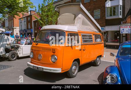 Un camper Volkswagen arancione degli anni '1970 con il tetto rialzato sollevato. Pulmino VW per camper alla mostra di auto d'epoca e d'epoca. Foto Stock