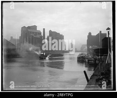 Fiume e ascensori, Buffalo, Foot of Main St., c1900. Chiatta trainata da motoscafo, con elevatori di grano oltre. Foto Stock