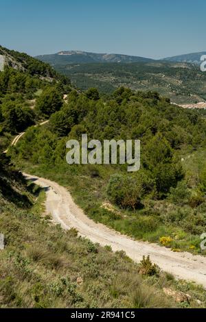 Piccola strada di montagna ghiaiosa che passa sopra una catena montuosa, Costa Blanca, Alicante, Spagna Foto Stock