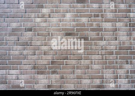 Sfondo da una nuova parete in mattoni grigi Foto Stock