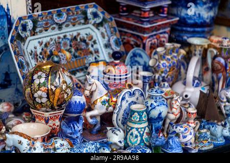 Amsterdam, NL - 10 ottobre 2021: Oggetti tradizionali in ceramica di Delftware esposti in un negozio di ceramiche di Amsterdam, NL. Foto Stock