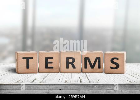 Termini firmare in un ufficio luminoso su una scrivania in legno con windows in background Foto Stock