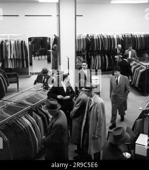 New York, New York: 1955 uomini che fanno shopping in un negozio di abbigliamento maschile. Foto Stock