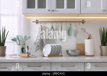 Set di diversi utensili e piatti sul piano di appoggio in cucina Foto Stock