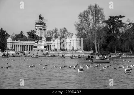 Madrid, Spagna - FEB 16, 2022: Gente che si diverte sulle barche a remi sullo stagno all'interno del Parco del Buen Retiro a Madrid, Spagna. Foto Stock