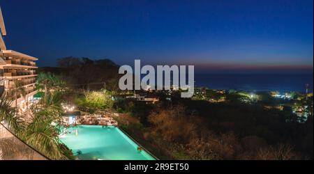 Resort di lusso illuminato con turisti nella piscina della costa rica Foto Stock