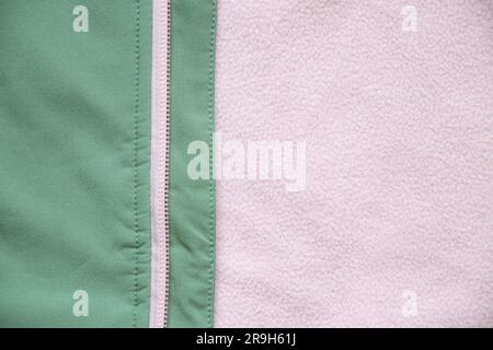 sfondo in tessuto morbido rosa verde con zip Foto Stock