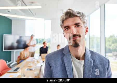 Ritratto di un uomo d'affari che indossa un blazer in sala conferenze Foto Stock