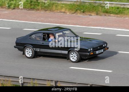 Anni '1979 70 '70 Ford Capri'S Black Car benzina 2994 cc; viaggia a velocità sostenuta sull'autostrada M6 a Greater Manchester, Regno Unito Foto Stock