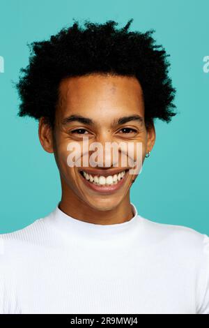 giovane adulto con acconciatura afro sorridente, guardando la macchina fotografica, scatto in studio alla testa Foto Stock