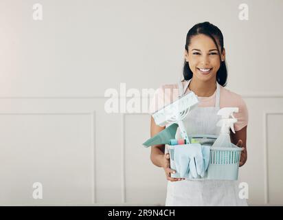 Donna, prodotti per la pulizia e sorriso in ritratto, spray chimici e igiene con prodotti per la manutenzione domestica. Detergente femminile felice, attrezzi per camerieri in Foto Stock