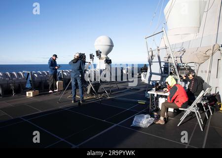 Orion Splash Down e Recovery Operations. I membri del team degli affari pubblici del Kennedy Space Center si preparano per la copertura in diretta dello splashdown della navicella spaziale Orion della NASA per la missione Artemis i mentre si trovano a bordo della USS Portland. Orion si è schiantato in sicurezza nell'Oceano Pacifico l'11 dicembre 2022, completando una missione di 25,5 giorni intorno alla Luna e ritorno. Foto Stock