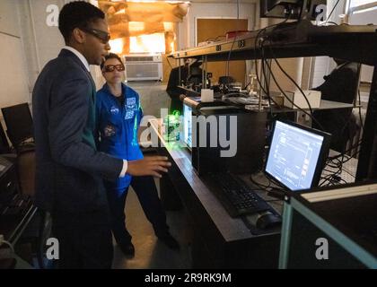 L'astronauta Jessica Watkins alla Howard University. Lo studente della Howard University Miles Phillips dà all'astronauta della NASA Jessica Watkins una dimostrazione del suo lavoro con i laser durante un tour del Nuclear and Particle Physics Detector Laboratory presso la Howard University, venerdì 31 marzo 2023, a Washington. Foto Stock