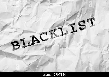 Black Word Blacklist su white paper crumpled Foto Stock