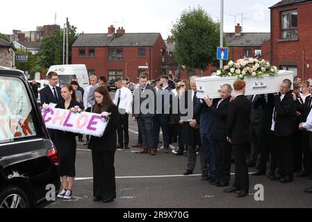 Le sorelle di Chloe Mitchell, Kirsty (a sinistra) e Nadine, portano una corona davanti alla sua bara mentre viene portata lungo Larne Street, a Ballymena. Data foto: Giovedì 29 giugno 2023. Foto Stock