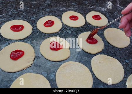 Cucina sveva, Kraepfle della Svevia superiore con Gsaelz, pasticceria dolce, preparazione ciambelle ripiene con marmellata, ripieno di pasta con fragole Foto Stock