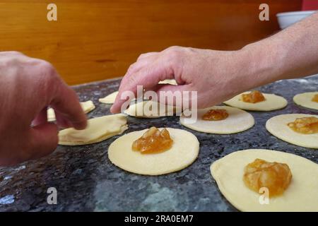 Cucina sveva, Kraepfle della Svevia superiore con Gsaelz, pasticceria dolce, preparazione di ciambelle ripiene con marmellata, impasto pieghevole con arancia Foto Stock