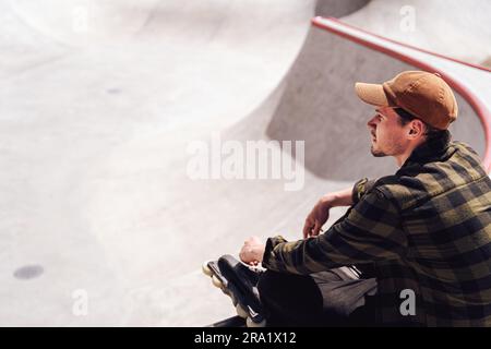 aggressivo skater che si rilassa nello skatepark Foto Stock